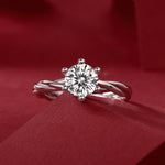 Load image into Gallery viewer, Éclat Entrelacé Moissanite Ring on a red fabric background