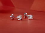Load image into Gallery viewer, Silver moissanite stud earrings on a red background