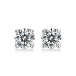 Load image into Gallery viewer, A pair of round-cut moissanite stud earrings held in a four-prong setting, on a white background.