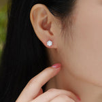 Load image into Gallery viewer, Close-up of a person wearing Eclat Royal Moissanite Stud Earrings