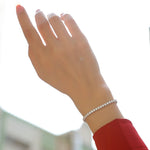 Load image into Gallery viewer, Hand wearing a moissanite tennis bracelet
