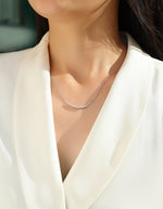 Load image into Gallery viewer, Arc Pavé Moissanite Necklace worn by a person in a white outfit
