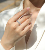 Load image into Gallery viewer, Close-up of a hand wearing Célébration Éternelle Moissanite Band
