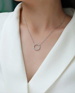 Load image into Gallery viewer, Cercle d&#39;Élégance Moissanite Necklace worn by a model in a white outfit.
