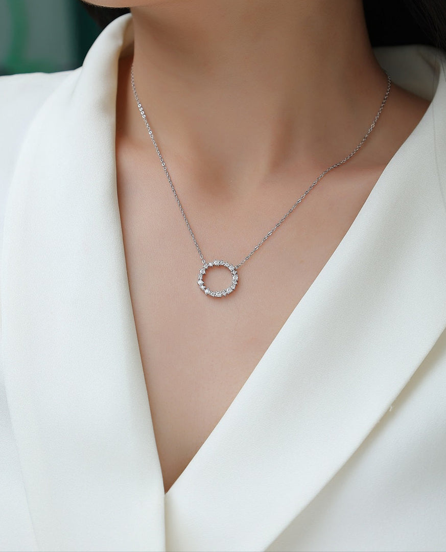 Cercle d'Élégance Moissanite Necklace worn by a model in a white outfit.