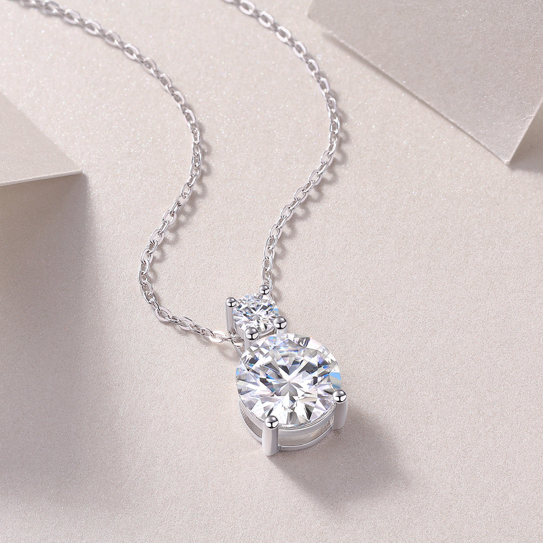 A moissanite silver necklace featuring a dual-stone design with round-cut moissanite stones.