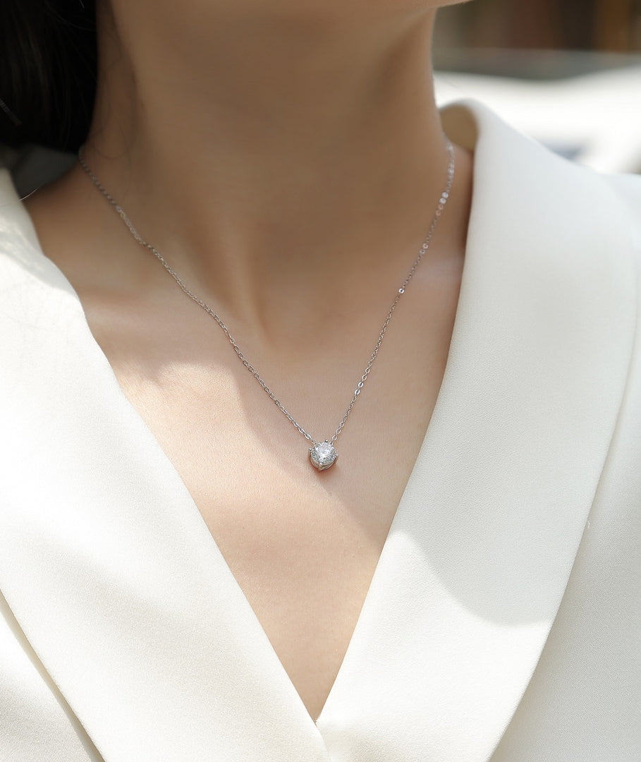 Éclat Classique Moissanite Necklace worn by a person in a white outfit.
