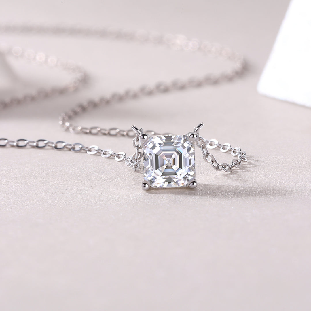 Éclat Cube Moissanite Necklace featuring a square-shaped Asscher-cut moissanite stone with a four-prong setting, displayed against a neutral background.