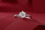 Load image into Gallery viewer, Éclat Entrelacé Moissanite Ring on a red fabric background
