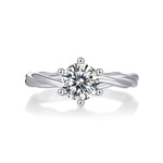 Load image into Gallery viewer, A round-cut moissanite ring with a twisted band design, set in a platinum band.
