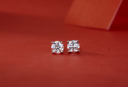 Moissanite stud earrings on a red background