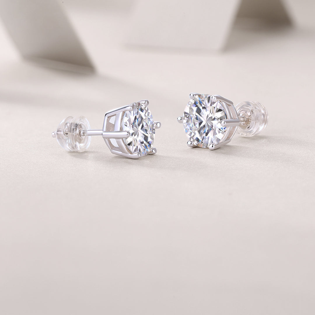 A pair of round-cut moissanite stud earrings with a classic six-prong setting on a white background.