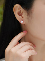 Load image into Gallery viewer, Close-up of a person wearing Eclat Royal Moissanite Stud Earrings
