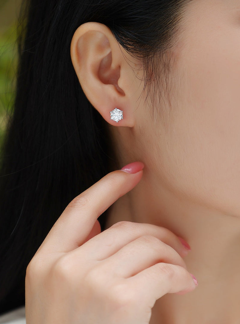 Close-up of a person wearing Eclat Royal Moissanite Stud Earrings