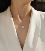 Load image into Gallery viewer, Éclat Solitaire Moissanite Necklace worn by a model in a white blazer.
