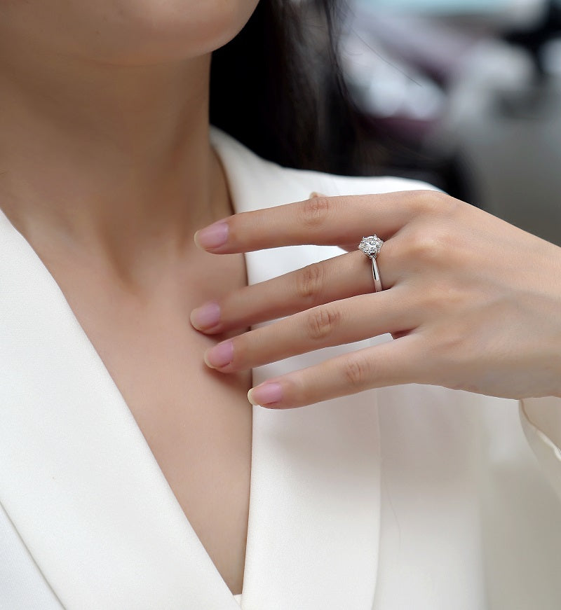 Close-up of a hand wearing Éclat Solitaire Moissanite Ring
