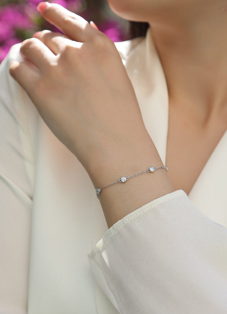 Close-up of a person wearing Élégance Classique Moissanite Bracelet