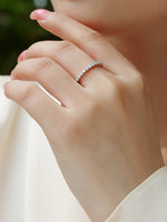 Load image into Gallery viewer, Close-up of a hand wearing Élégance Infinie Moissanite Band
