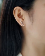 Load image into Gallery viewer, Close-up of an ear wearing Elegance en Croix Moissanite Earrings
