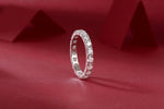 Load image into Gallery viewer, Éternelle Majesté Moissanite Band on a red fabric background
