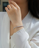 Load image into Gallery viewer, Close-up of a person wearing Eternelle Princesse Moissanite Tennis Bracelet
