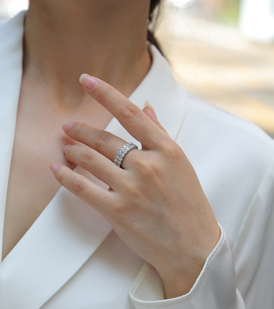 Close-up of a hand wearing a Pavé Royale Moissanite Band
