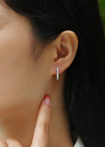 Load image into Gallery viewer, Close-up of a person wearing Pavé de Lumière Moissanite Hoop Earrings
