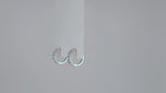 Load and play video in Gallery viewer, Éternelle Brillance Huggie Moissanite Earrings

